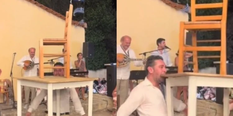 Απίστευτος τύπος χορεύει ζεϊμπέκικο κρατώντας με τα δόντια του ένα τραπέζι και μια καρέκλα (vid)